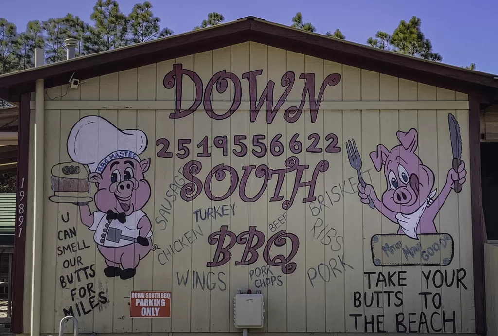 The Down South BBQ sign with pink pigs.