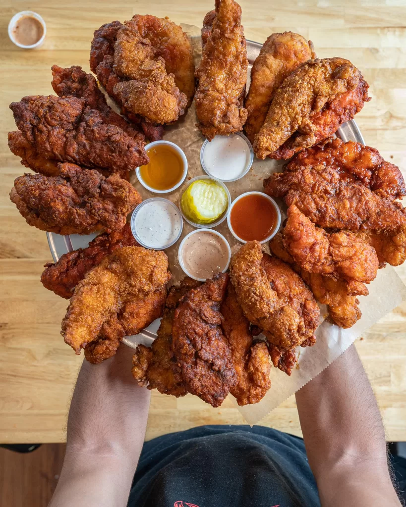 A platter of spicy chicken tenders in various red colors.