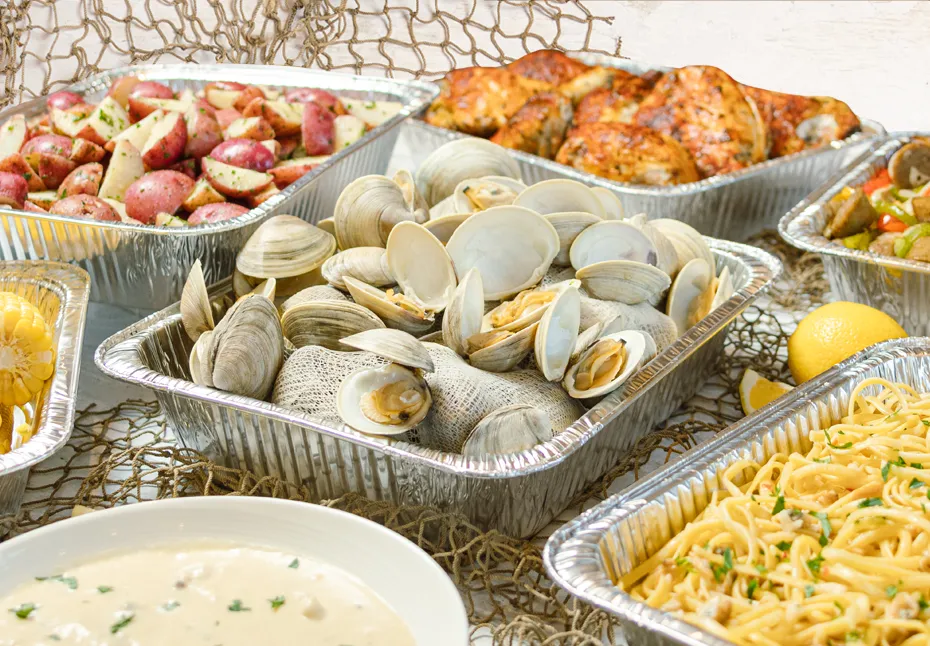 Metal pans of clams, chicken and potatoes